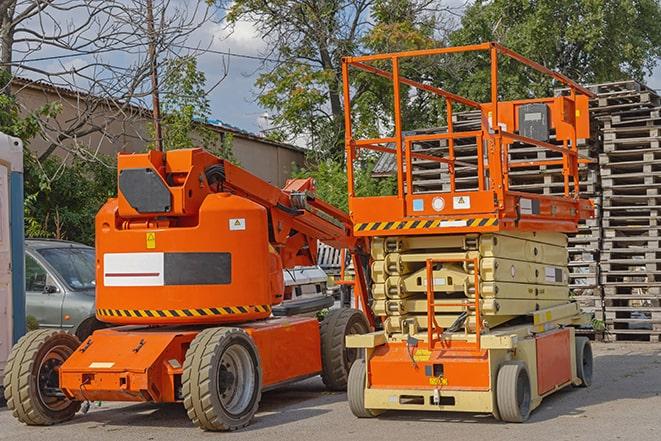 forklift carrying pallets in a busy warehouse in Cohoes